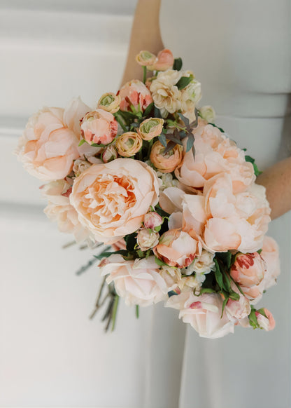 pink silk flower bouquet of roses, peonies, and ranunculus