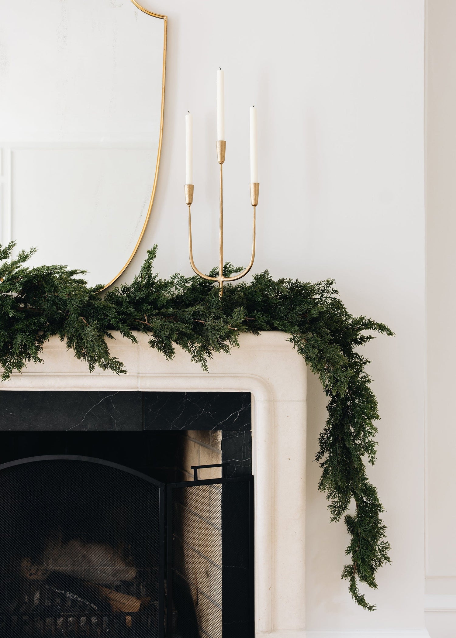 Gold Candelabra and Faux Holiday Greens Garland Styled on Mantel