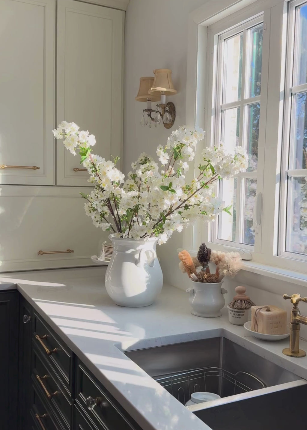 cherry blossoms arranged in a vase in the kitchen