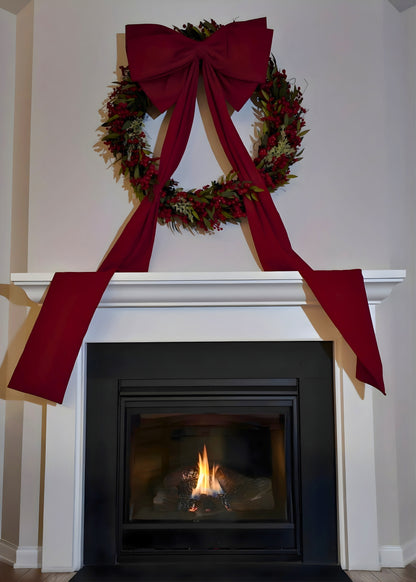 Large wreath and bow style over fireplace mantel