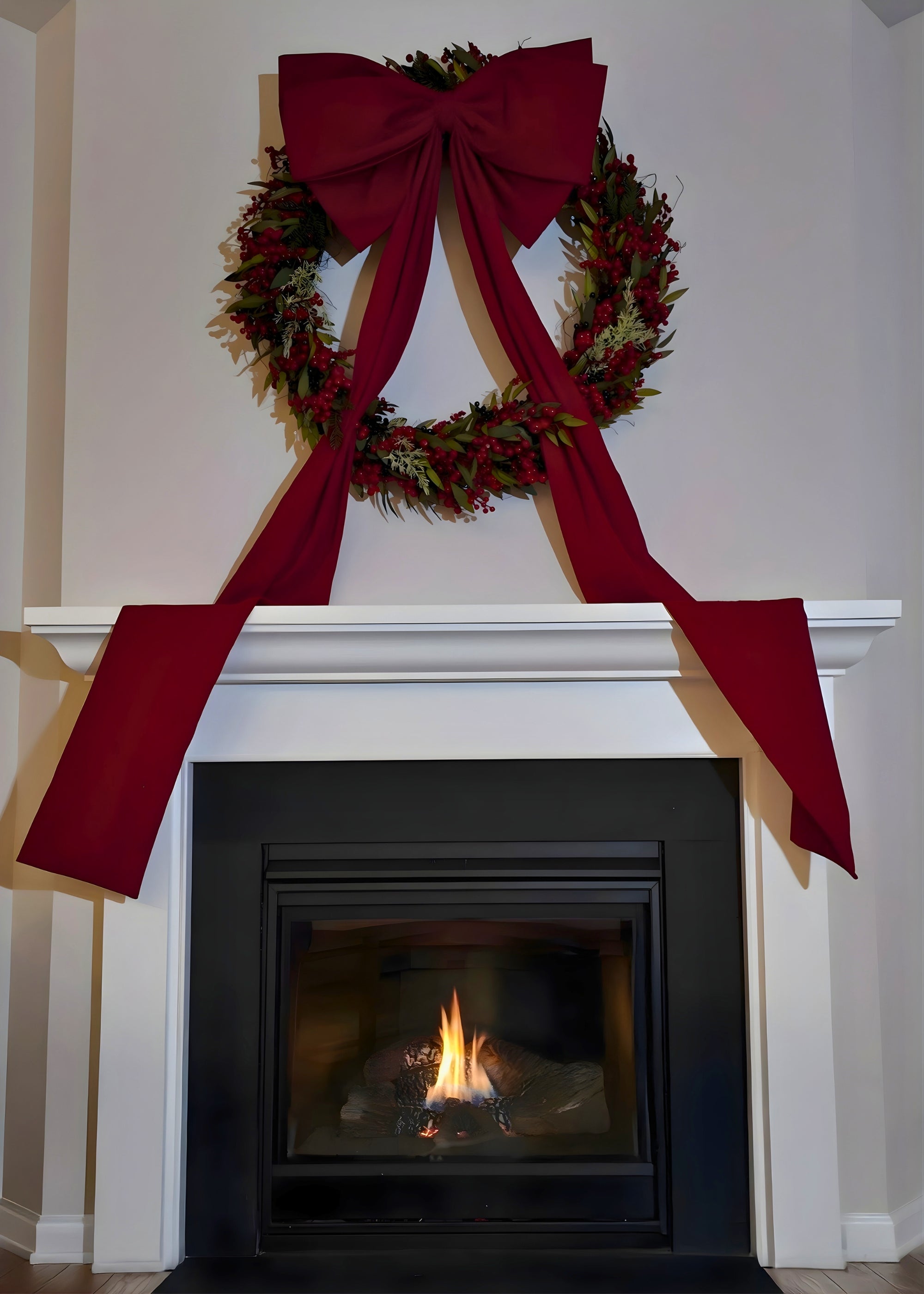 Large wreath and bow style over fireplace mantel