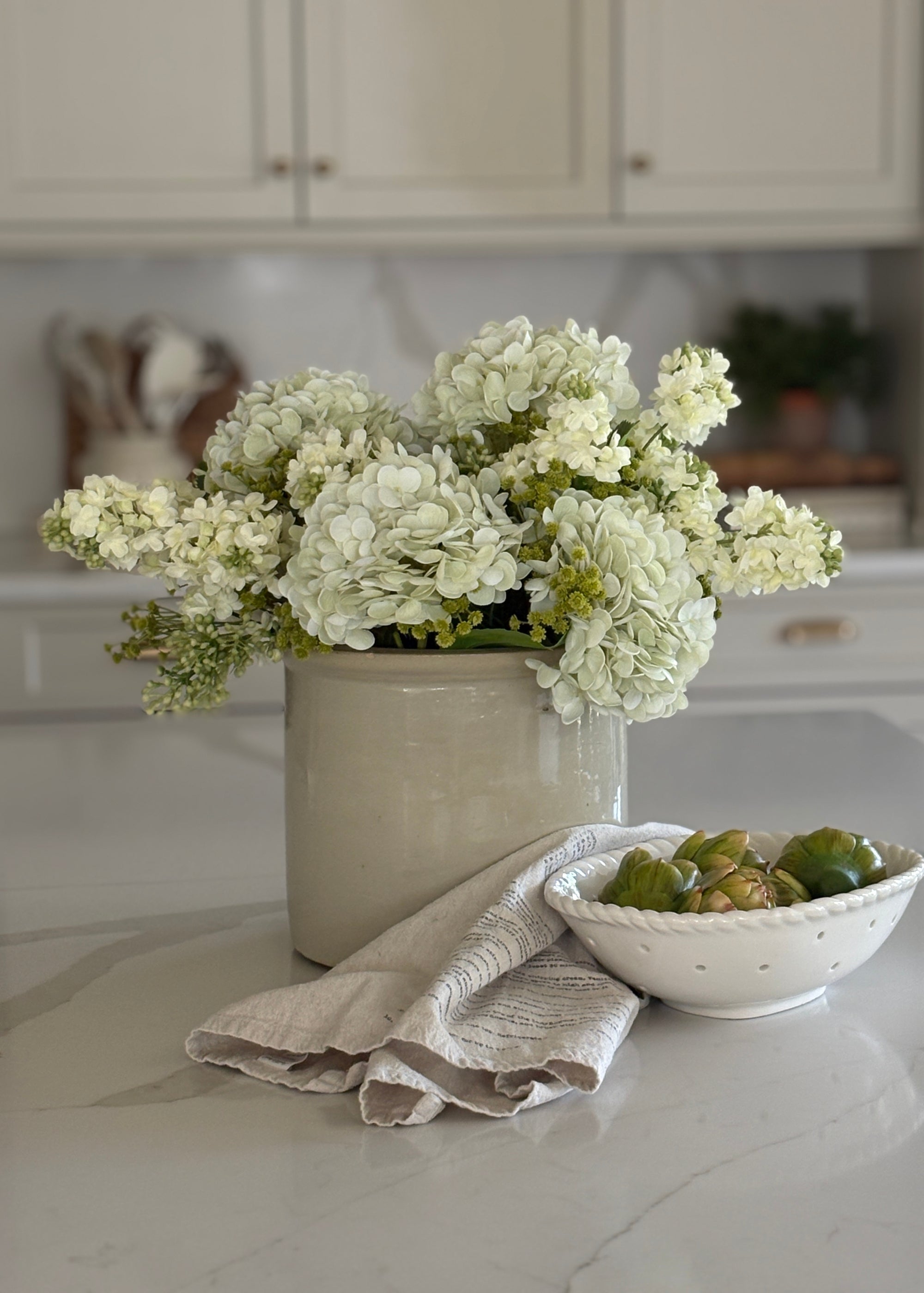 lilac, hydrangea, and baby's breath artificial flower arrangement