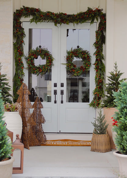 Front porch styled with faux pine wreaths and garlands