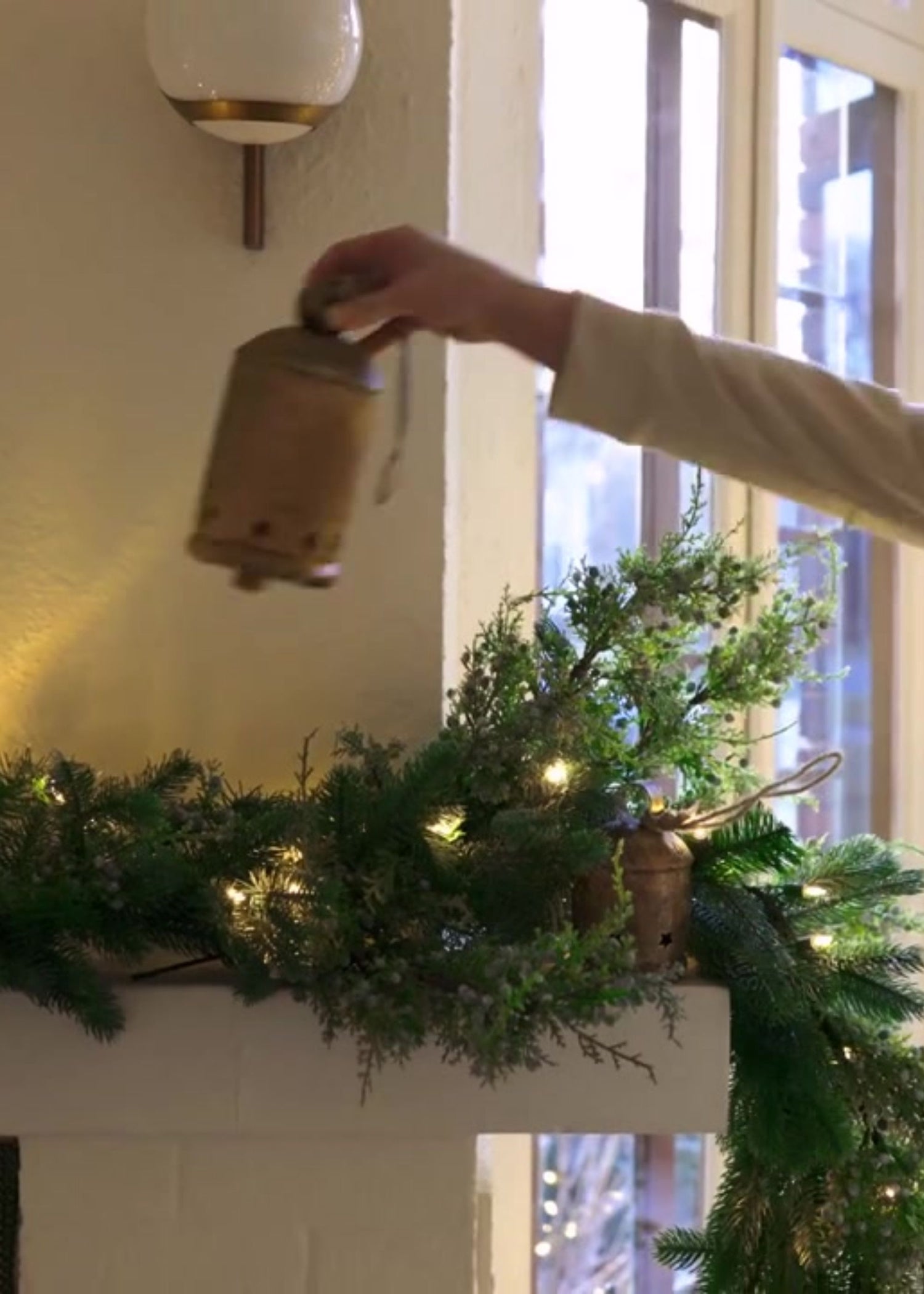 Decorating the Mantel with Large Gold Holiday Bells