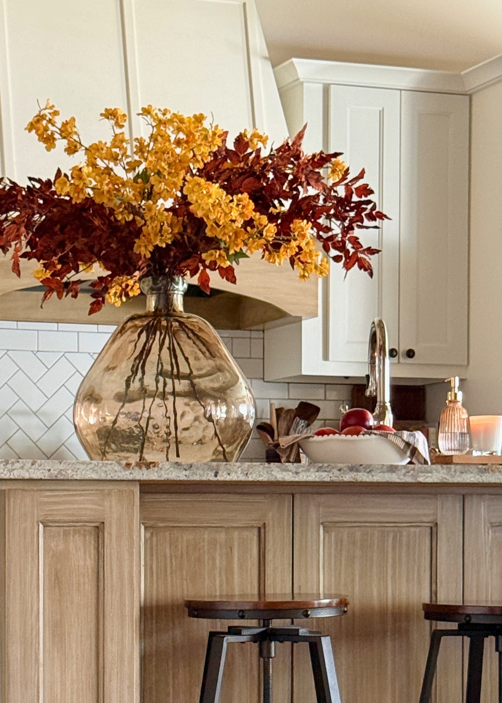 video of an arrangement made with faux fall yellow cherry blossoms and brown cimicifuga leaves