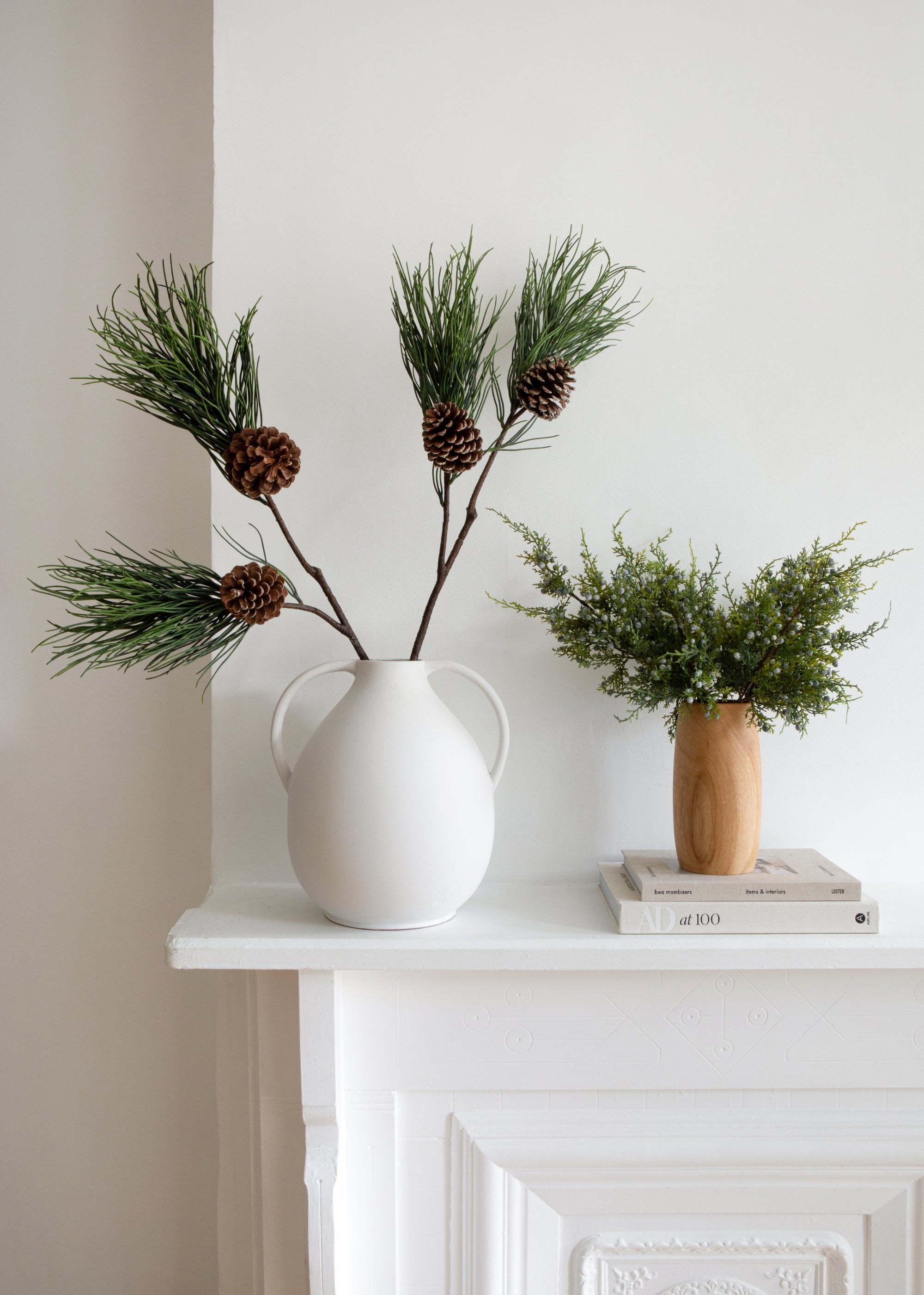 video of faux pine branch with pine cones
