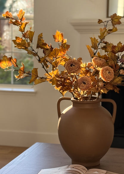 fall faux maple leaf and ranunculus floral arrangement