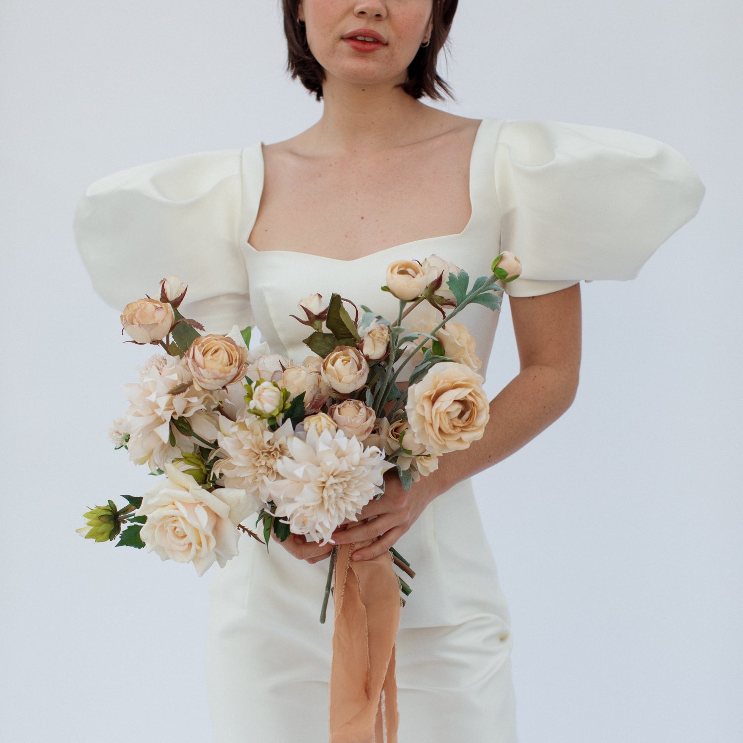 beige cream bridal bouquet with dahlias, roses, and ranunculus