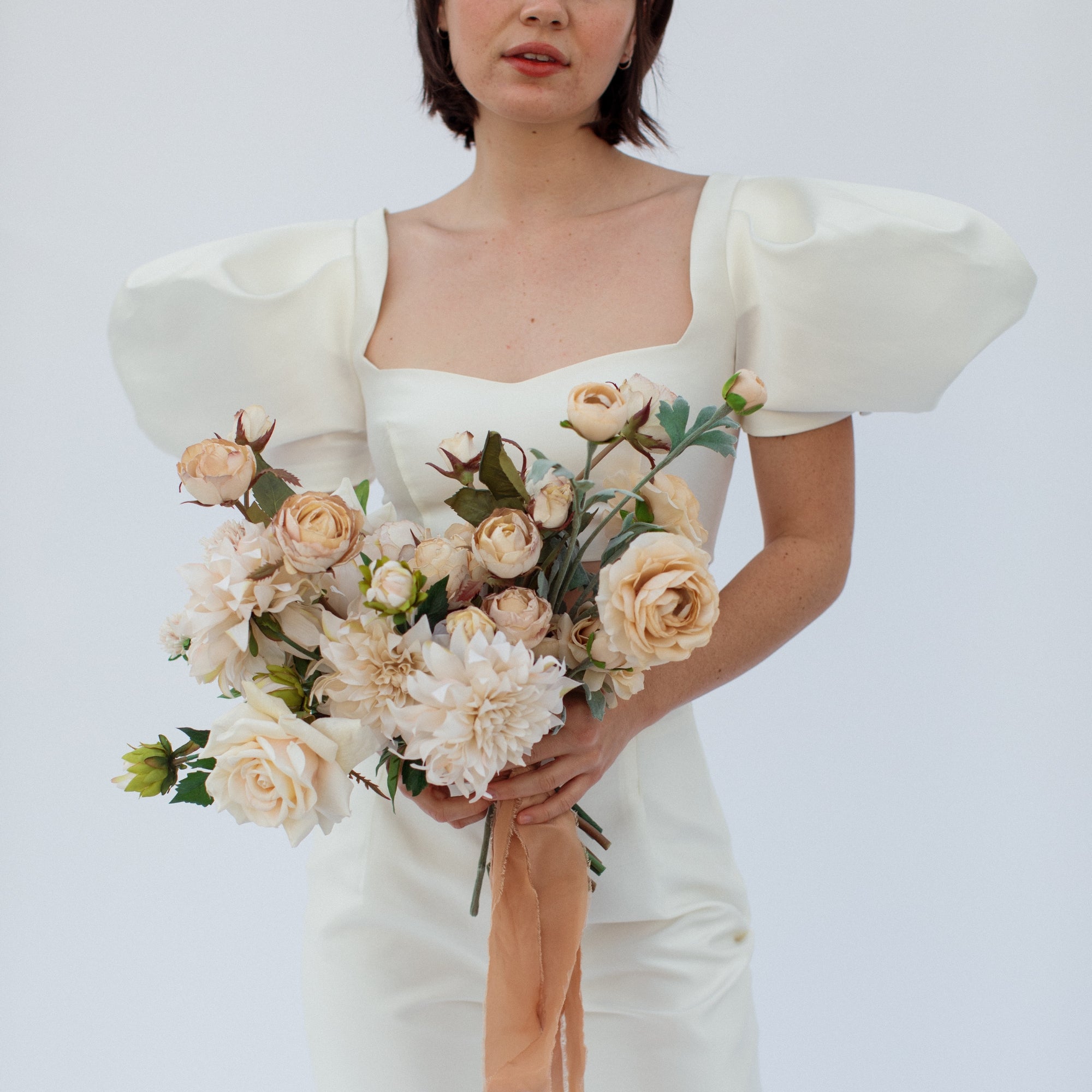beige cream bridal bouquet with dahlias, roses, and ranunculus