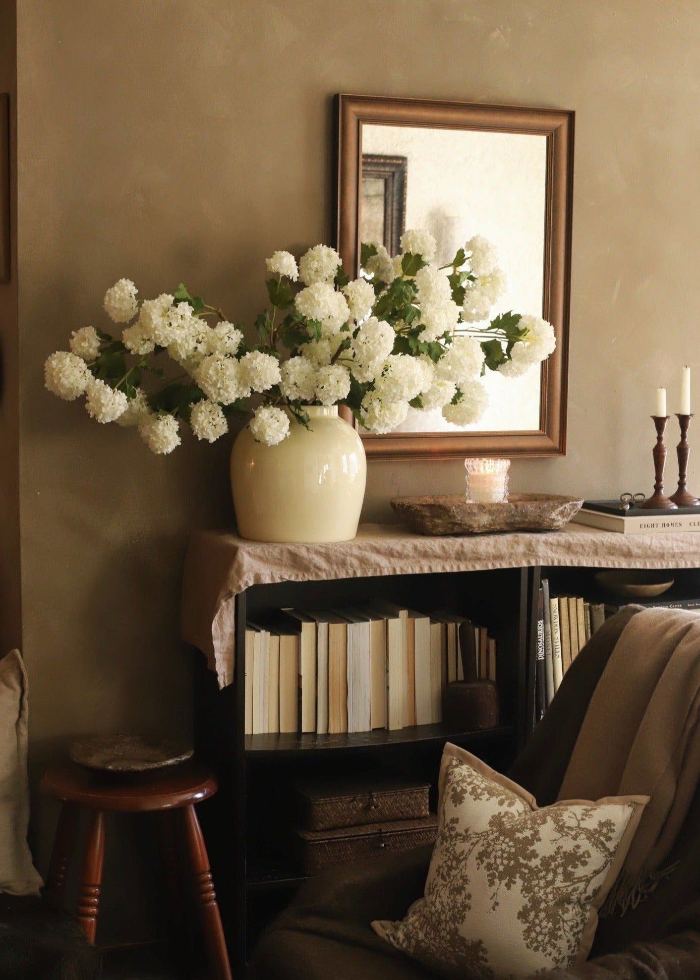 artificial white spring snowball flowers in glossy cream vase
