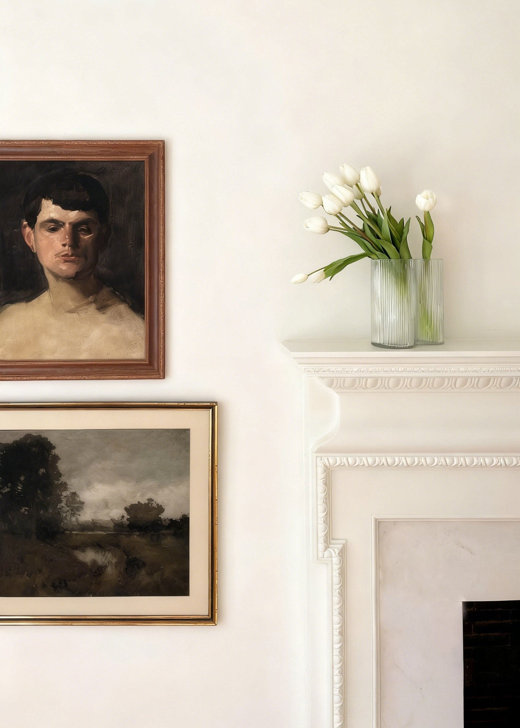 artificial tulips arranged in glass asymmetrical vase on a mantel