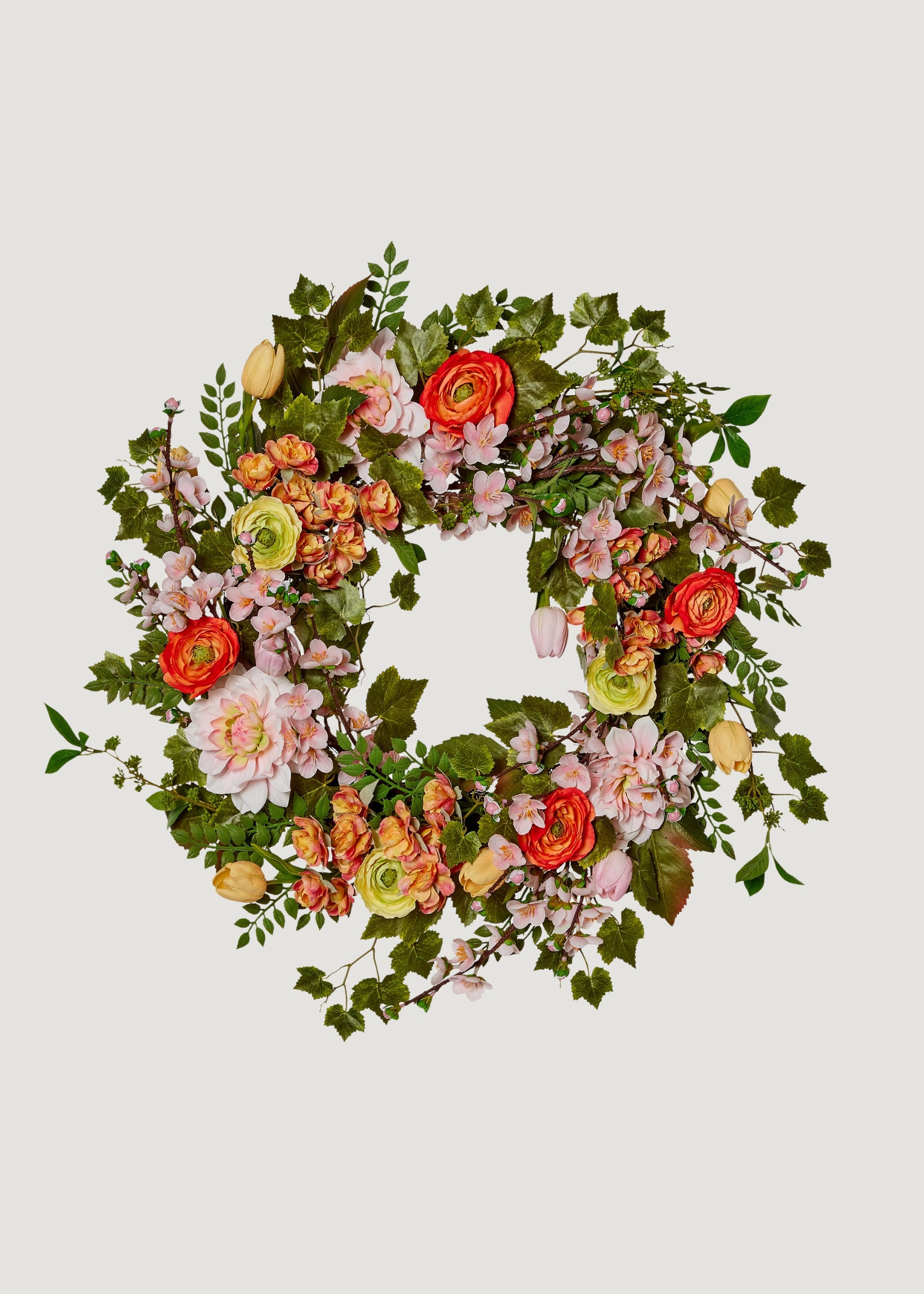 Fake garden wreath with ranunculus, dahlias, and blossoms
