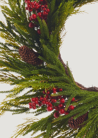Close-up of Fake Cedar Wreath with Red Berries and Pine Cones 