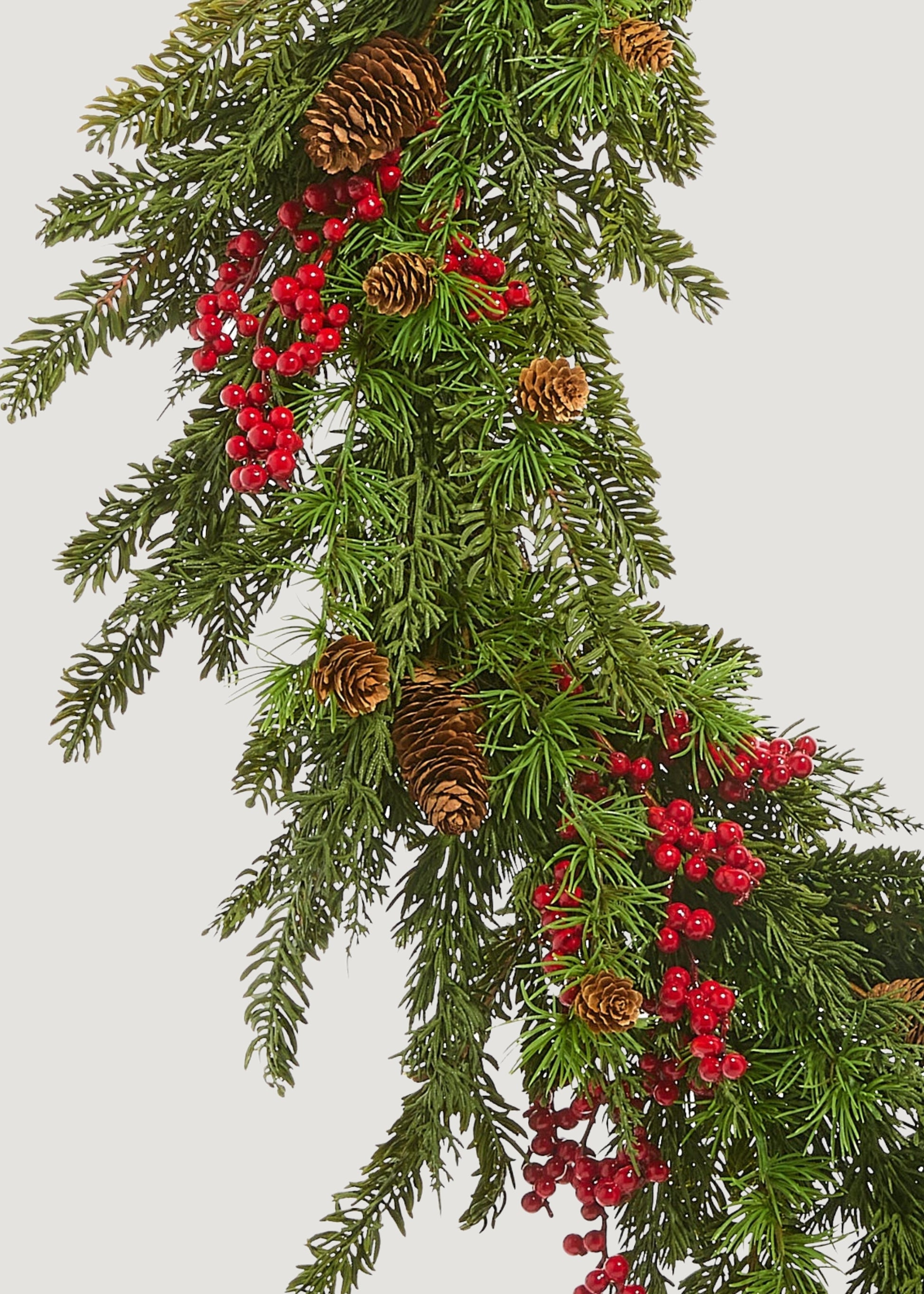 Close-up of faux cedar and red berry wreath