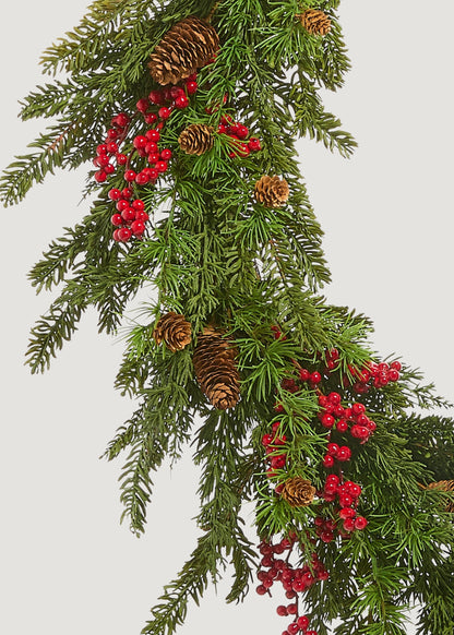 Close-up of faux cedar and red berry wreath