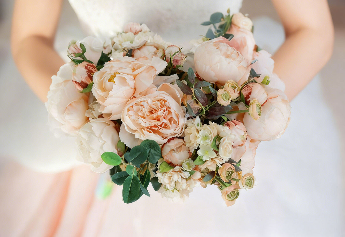 A wedding bouquet with blush pink faux flowers.