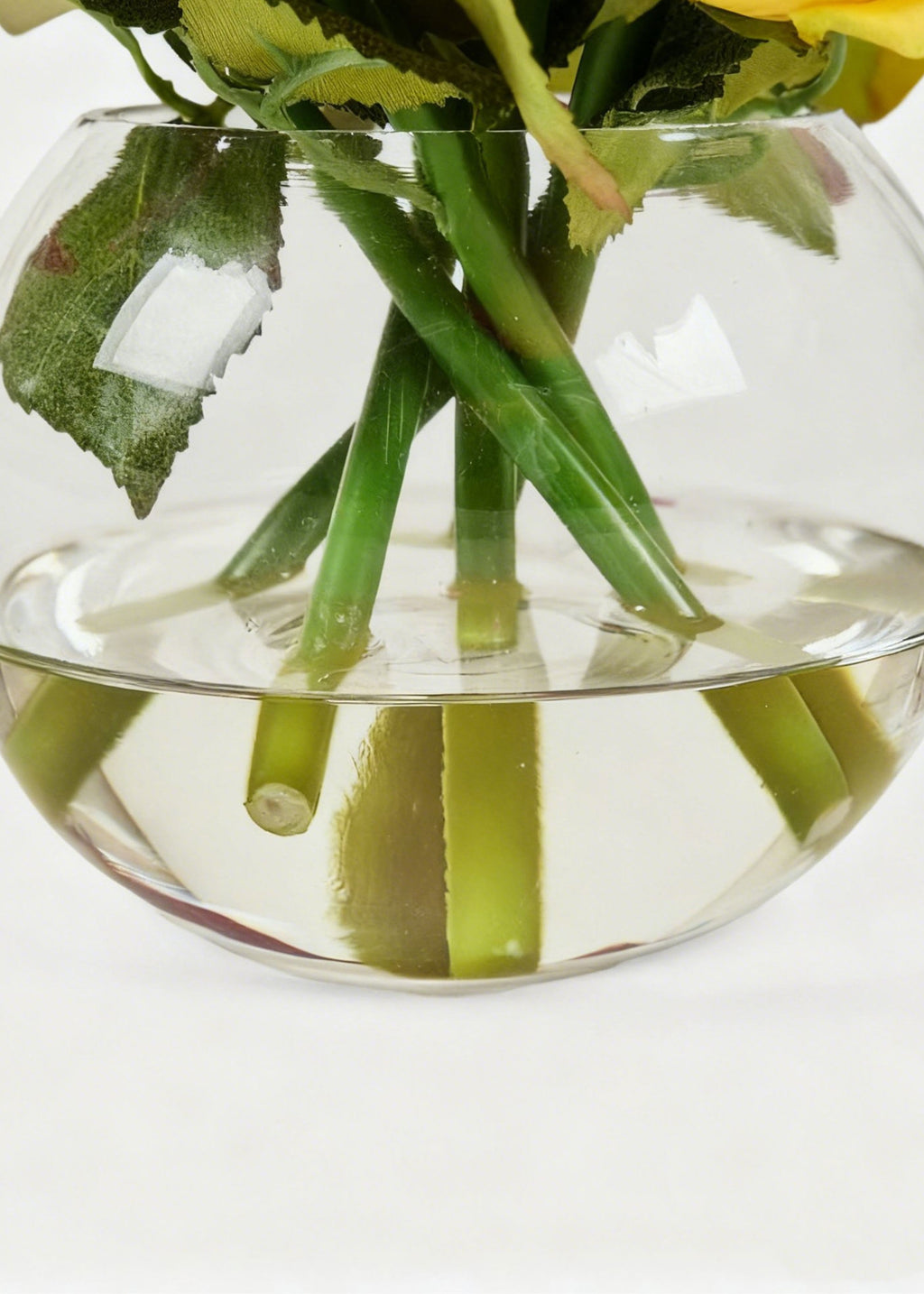 Close-up of clear vase and acrylic water with rose stems