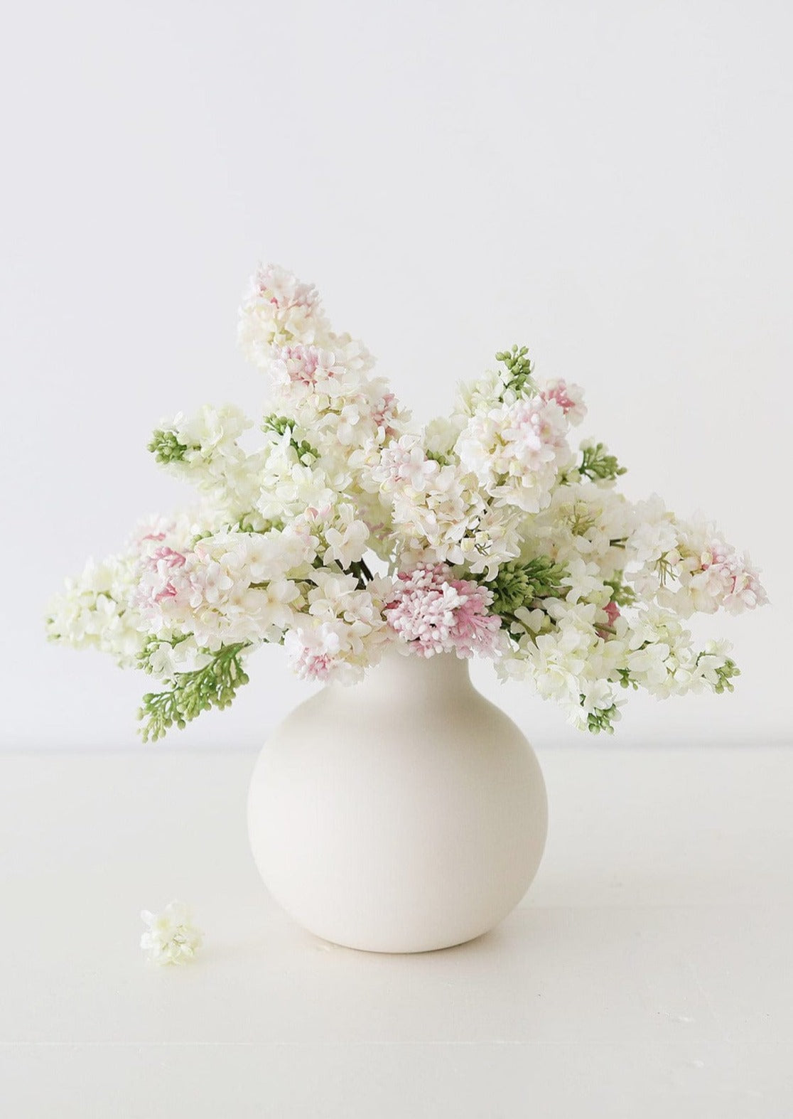 Cream and Pink Lilacs in Afloral White Round Vase