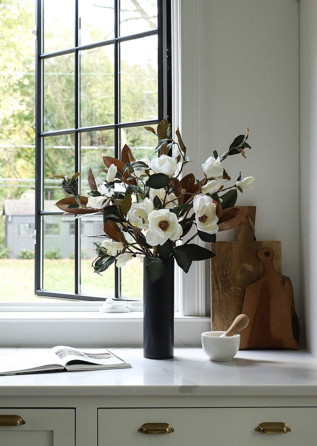 Faux Magnolia Branches in Black Cylinder Vase